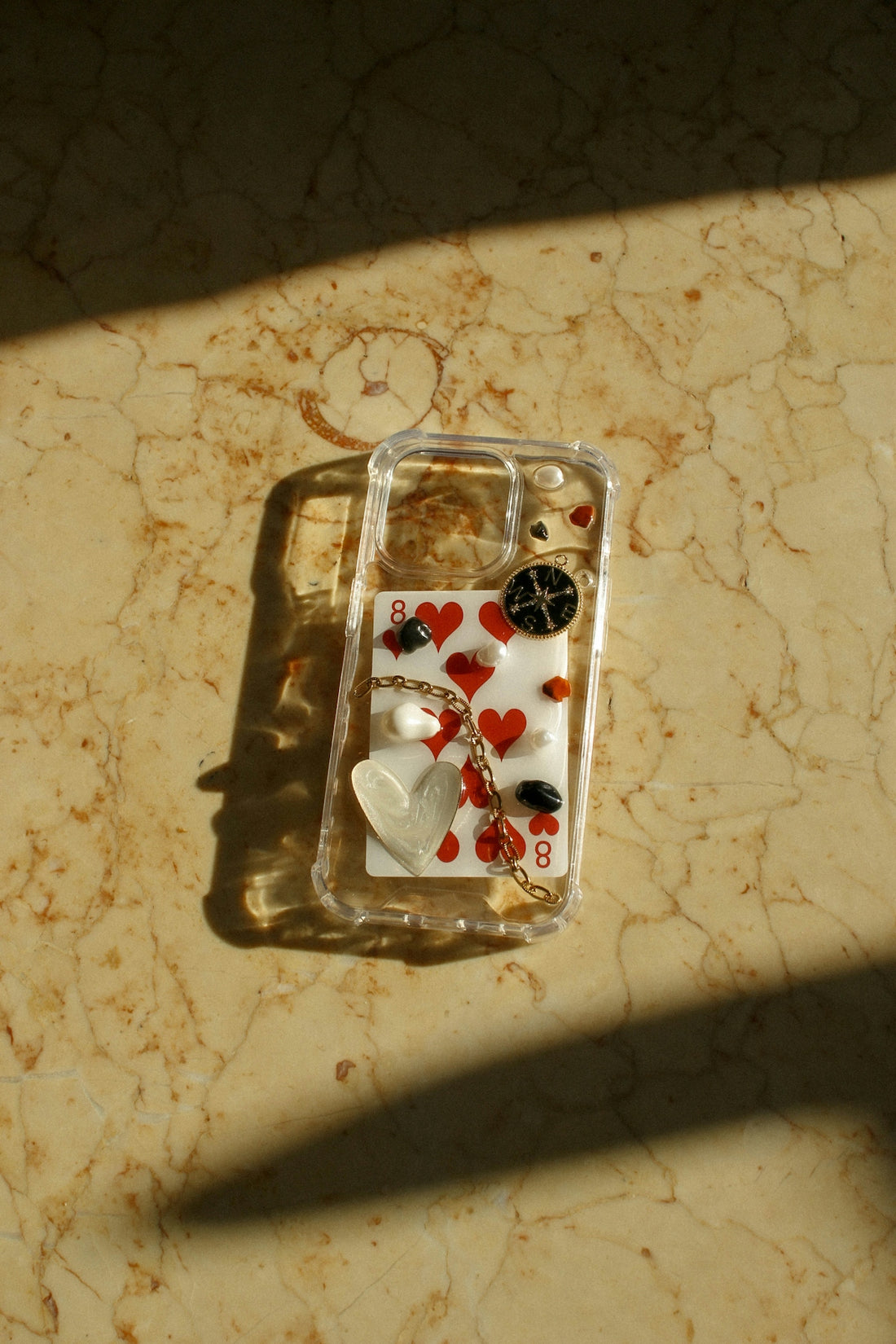 A cell phone case with hearts and buttons on it